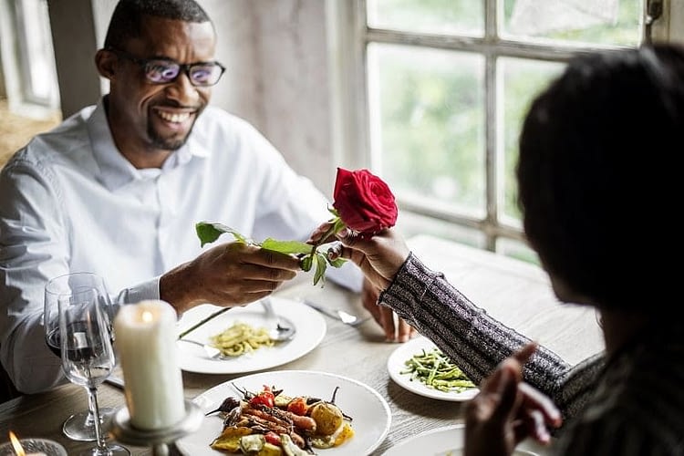 Romantic Man Giving a Rose to Woman on a Date