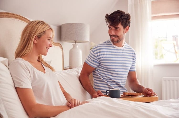 Husband Surprising Wife With Breakfast In Bed At Home